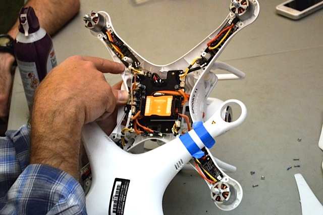 Drone with its protective cover off revealing inner workings.